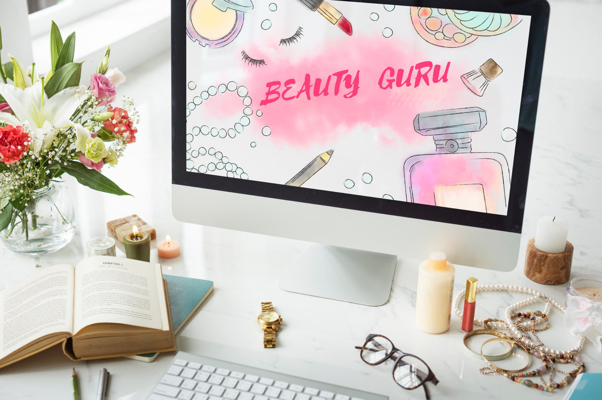 Beauty workspace with flowers, cosmetics and a Beauty Guru display